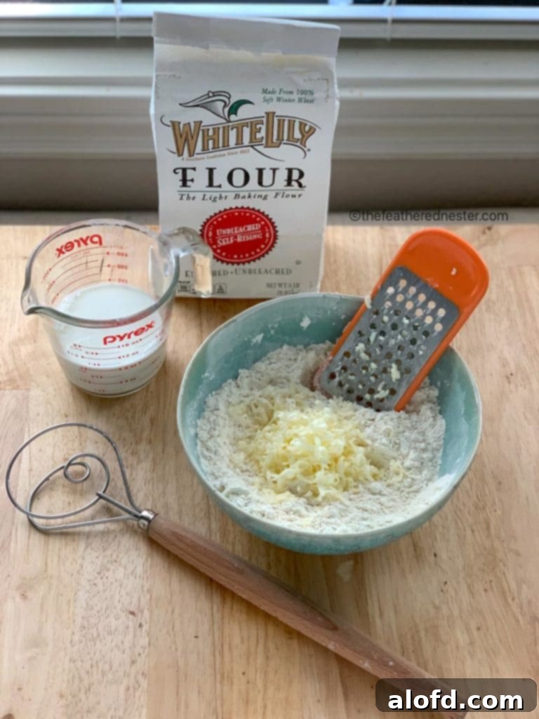 8 Simple Swaps for Egg-Free Cornbread 10 Package of self rising flour next to a blue bowl with grated butter, a measuring cup with buttermilk, and a whisk.