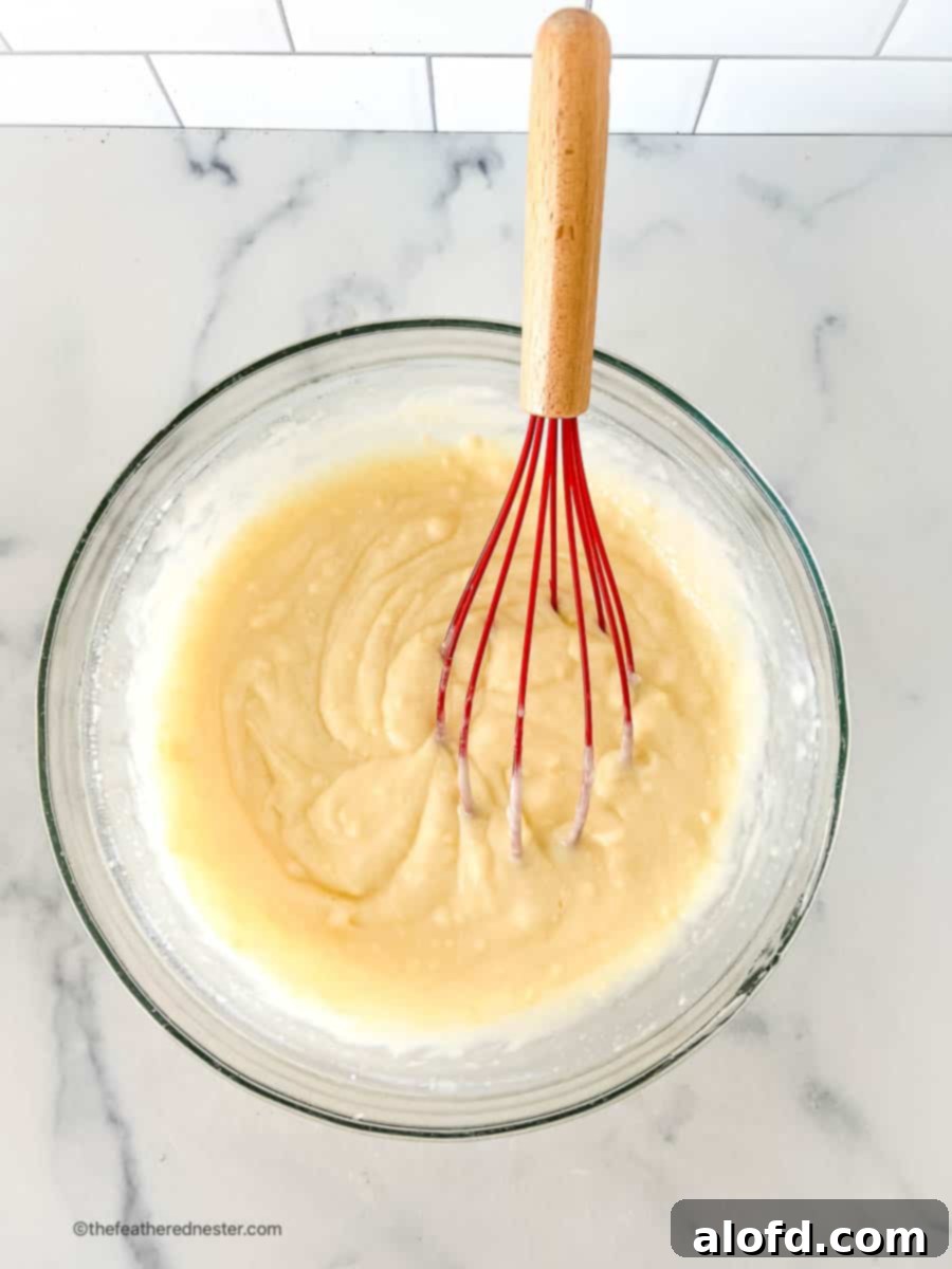 A bowl of creamy cheesecake pudding, freshly mixed and ready to be layered into the 4th of July salad.