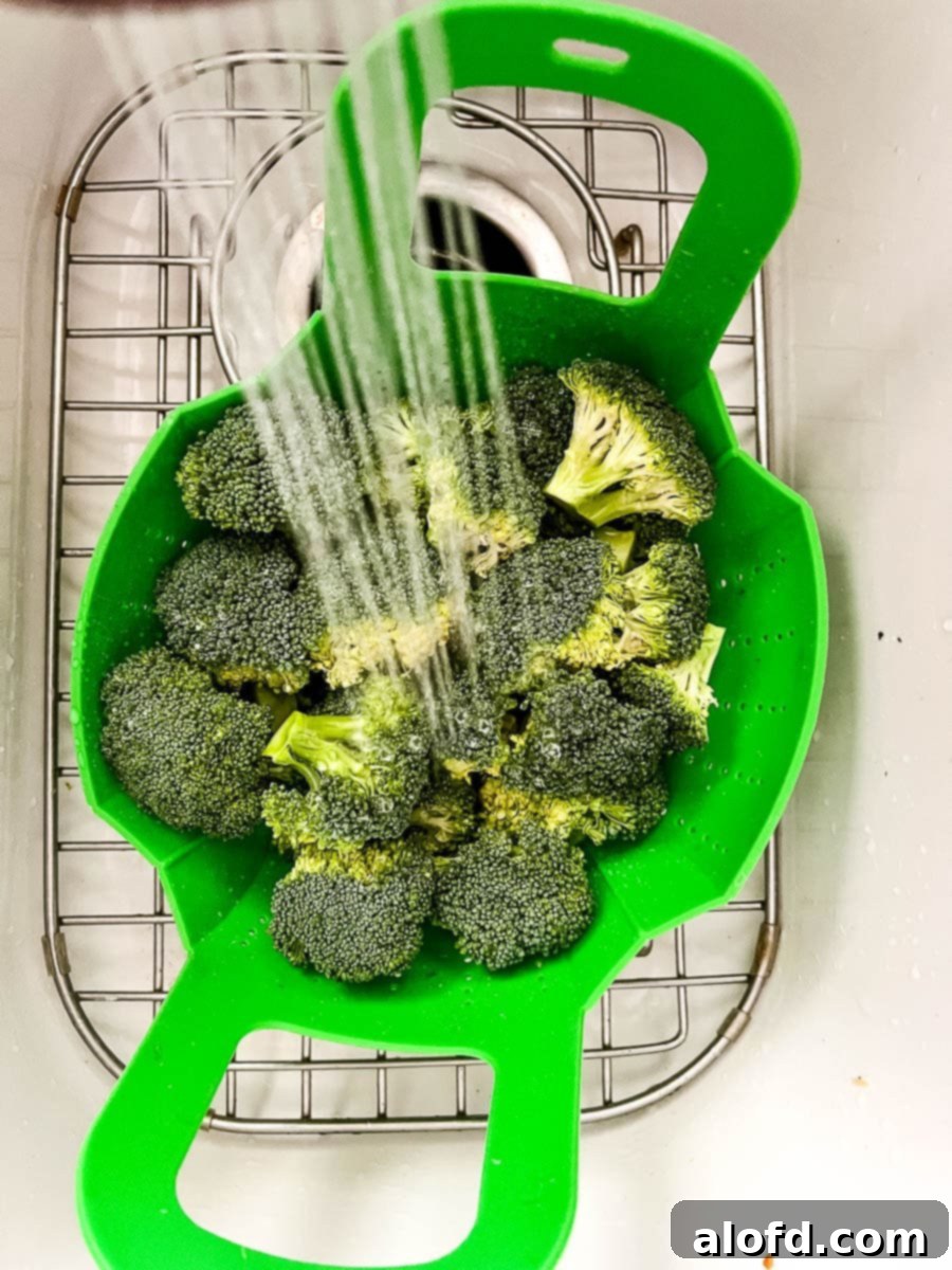 Shocking cooked green vegetables with cold water to stop the cooking.