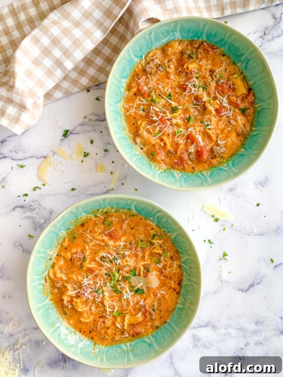 Hearty Instant Pot Lasagna Soup 2 Two green bowls of creamy lasagna soup cooked in a pressure cooker.