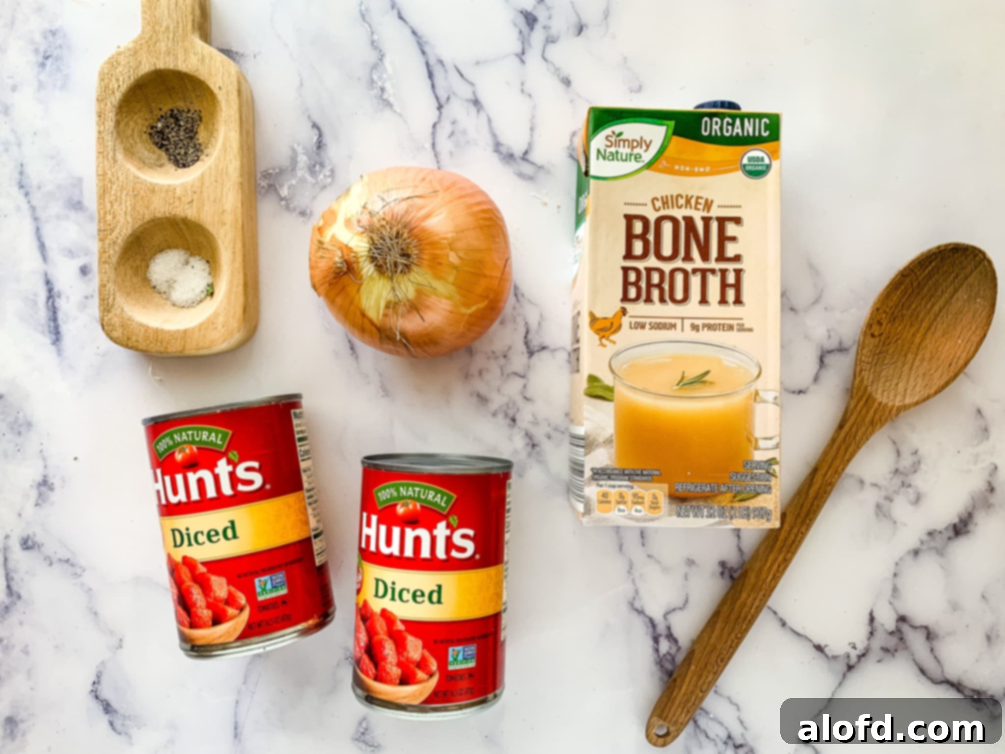 Hearty Instant Pot Lasagna Soup 6 Hunts diced tomatoes, an onion, and Simply Nature chicken bone broth and a wooden spoon.