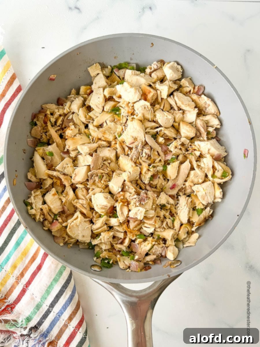 Flavorful Chicken Street Tacos 5 Bite sized pieces of Mexican seasoned white meat in a sauté pan.