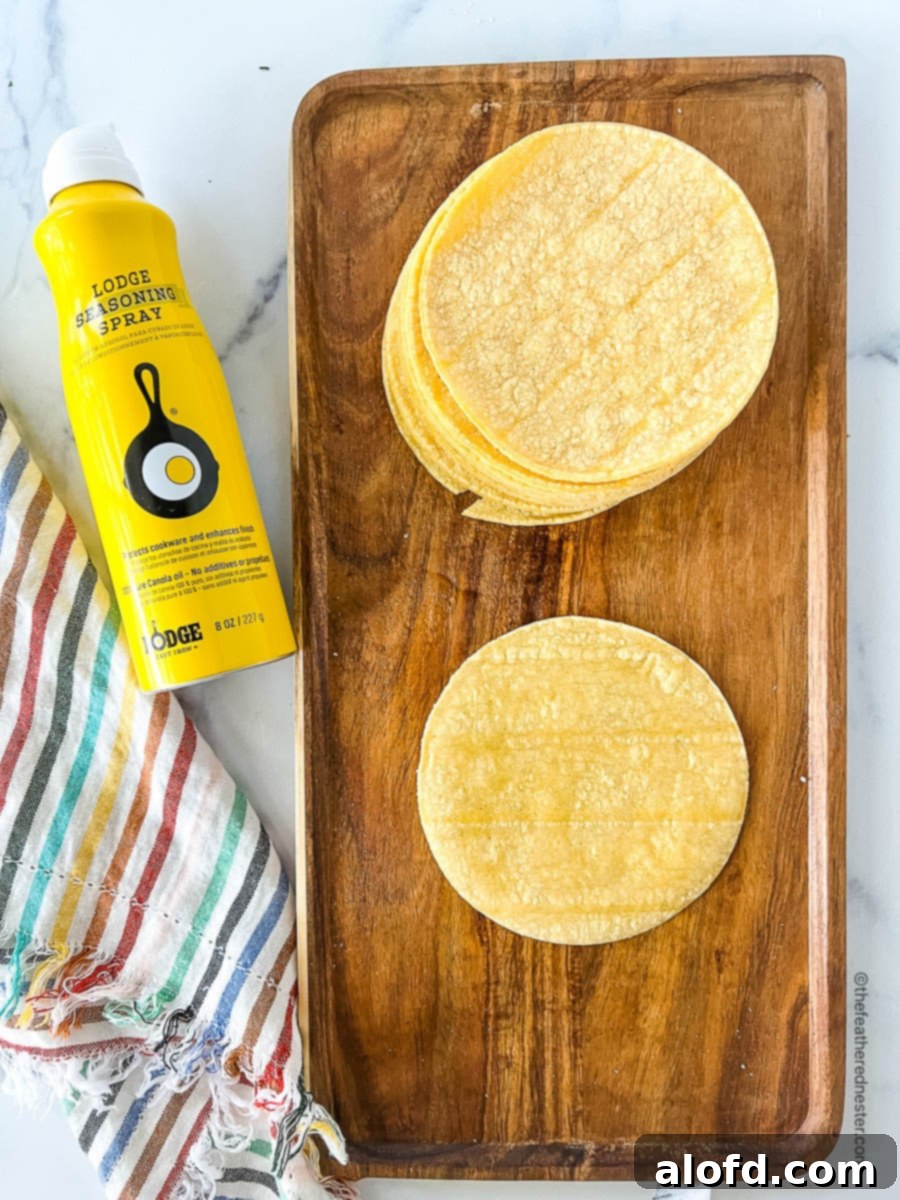 Flavorful Chicken Street Tacos 7 corn tortillas on a wooden tray next to can of non-stick cooking spray.