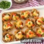 a white tray of taco wonton cups on top of a red and white napkin with a bowl o cilantro in the corner.