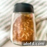 chicken taco spice mix inside a spice container, showcasing the vibrant colors and textures of the homemade blend.