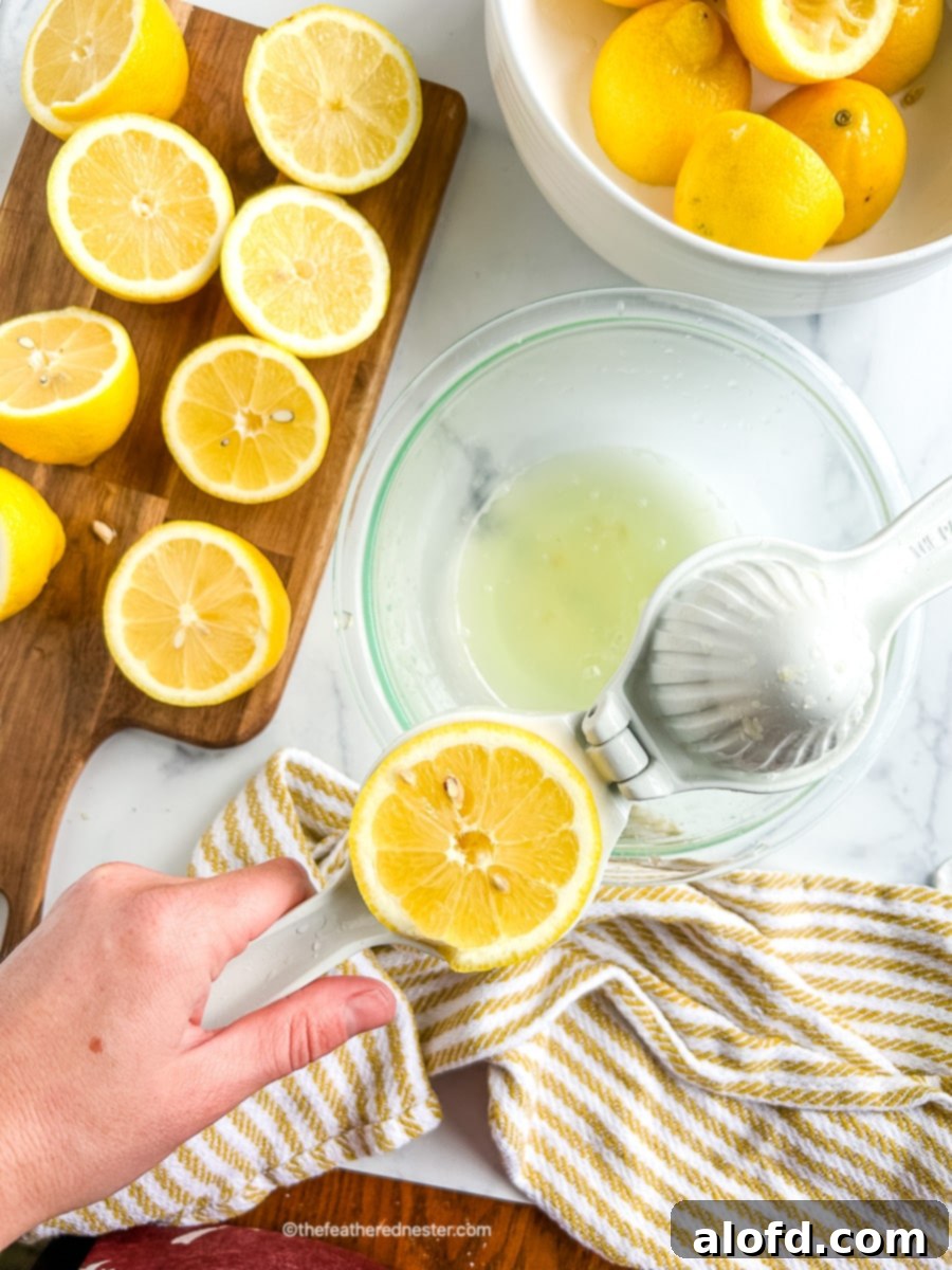 cutting board of cut citrus fruits next to a bowl full of lemon juice.