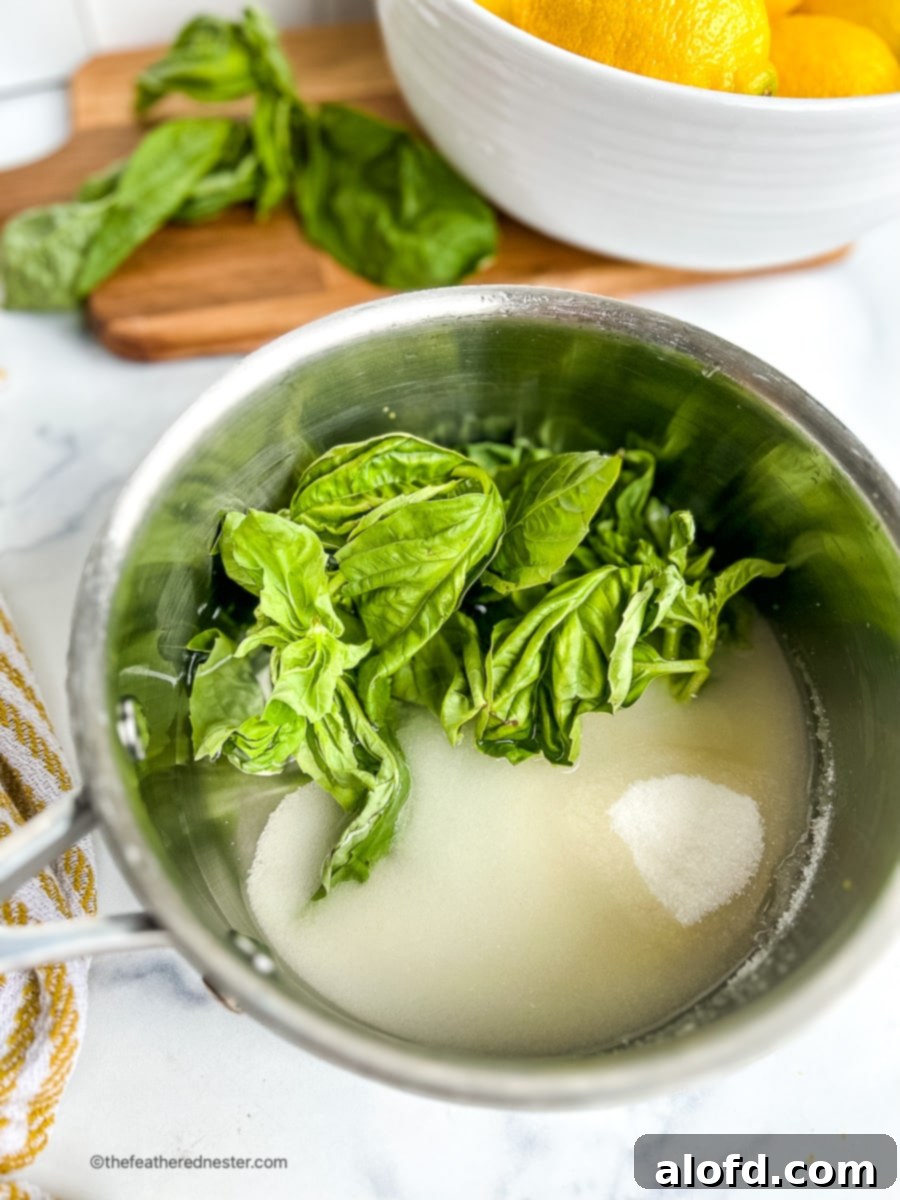 Saucepan of simple syrup with basil leaves.