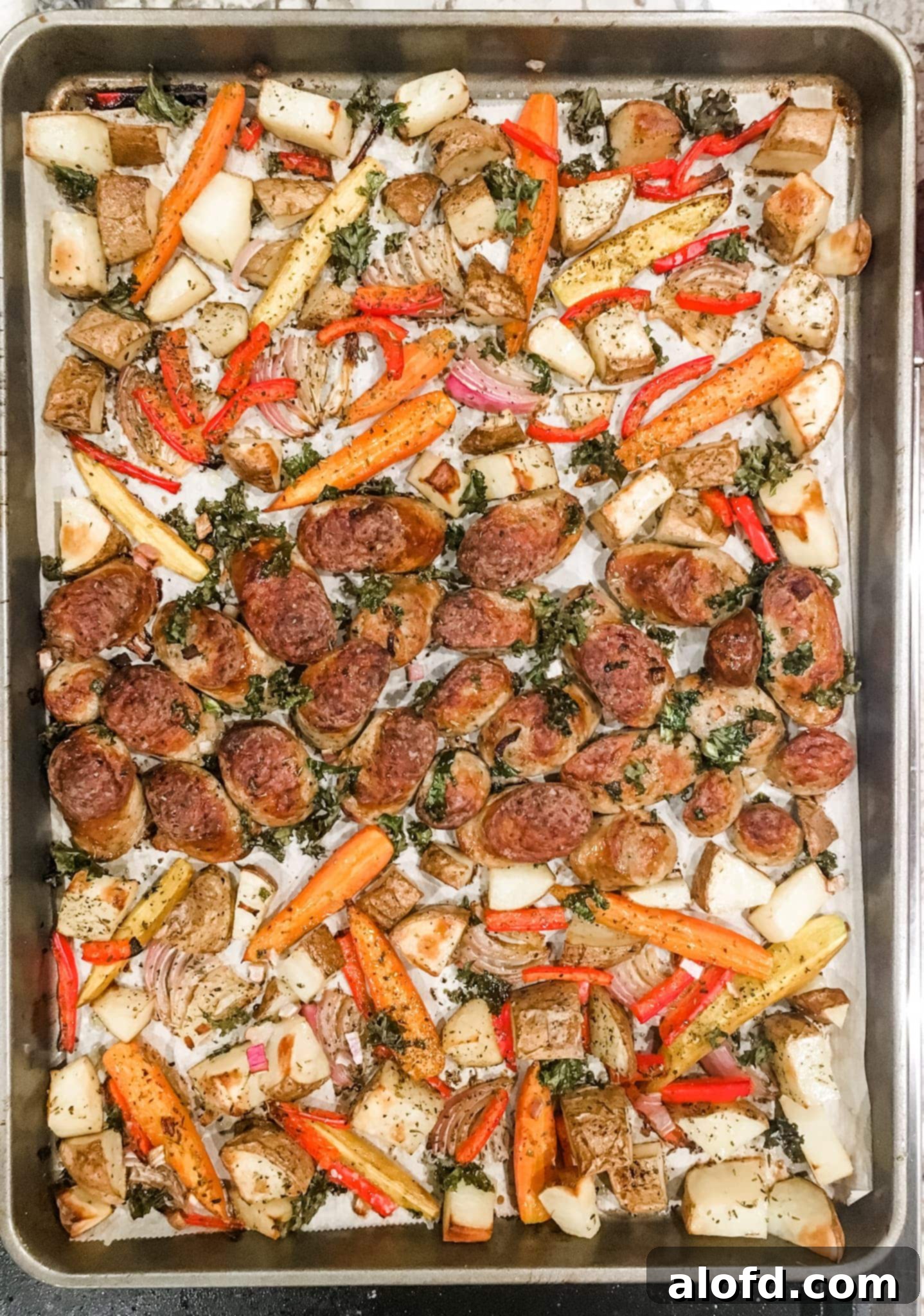 One-Pan Chicken Sausage and Roasted Vegetables 2 A vibrant sheet pan overflowing with golden-brown chicken sausage and perfectly roasted vegetables, ready to serve.