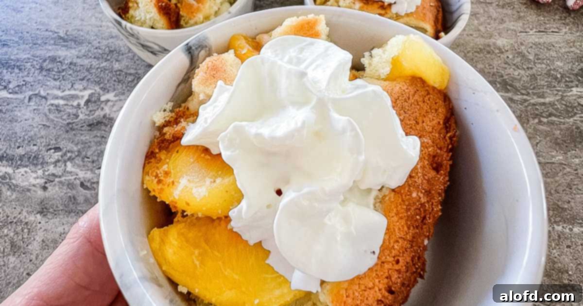 Extreme close up of peach dessert topped with whipped cream.