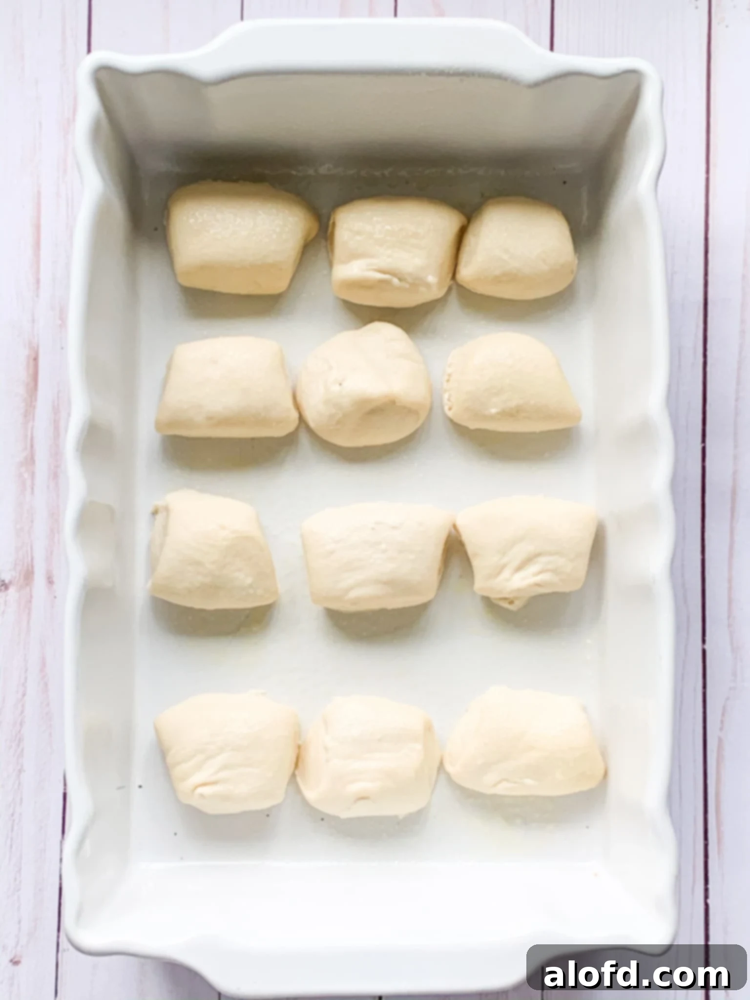 Zesty Italian Slider Bites 5 frozen dough for Super Bowl sliders in a baking dish.