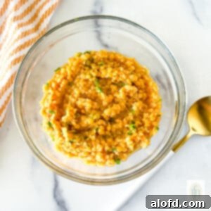 Small dish of cooked red lentils, perfectly prepared and ready for use in a variety of dishes.