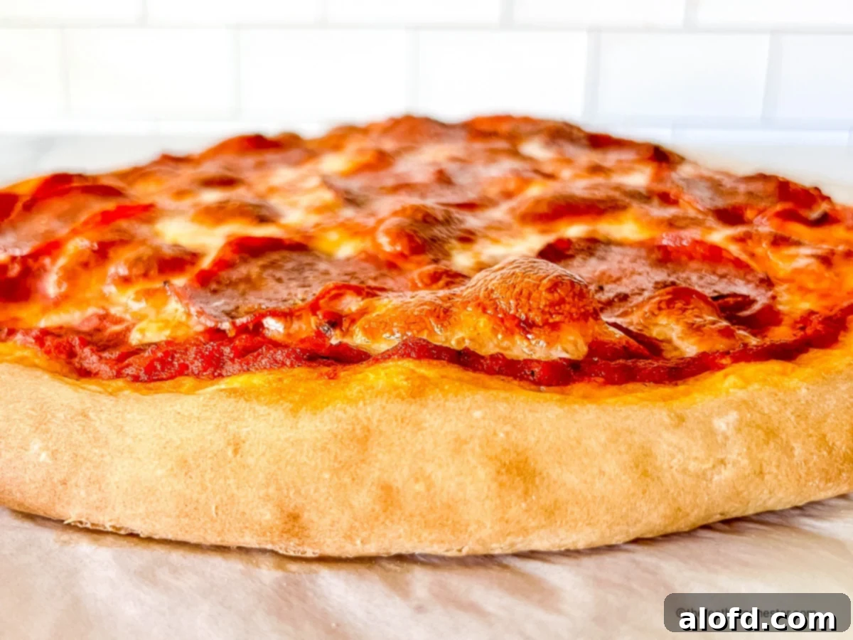 Foolproof Bisquick Pizza Dough 10 Side view of a perfectly baked homemade pizza, made with Bisquick pizza dough, showcasing its golden crust and melted cheese.