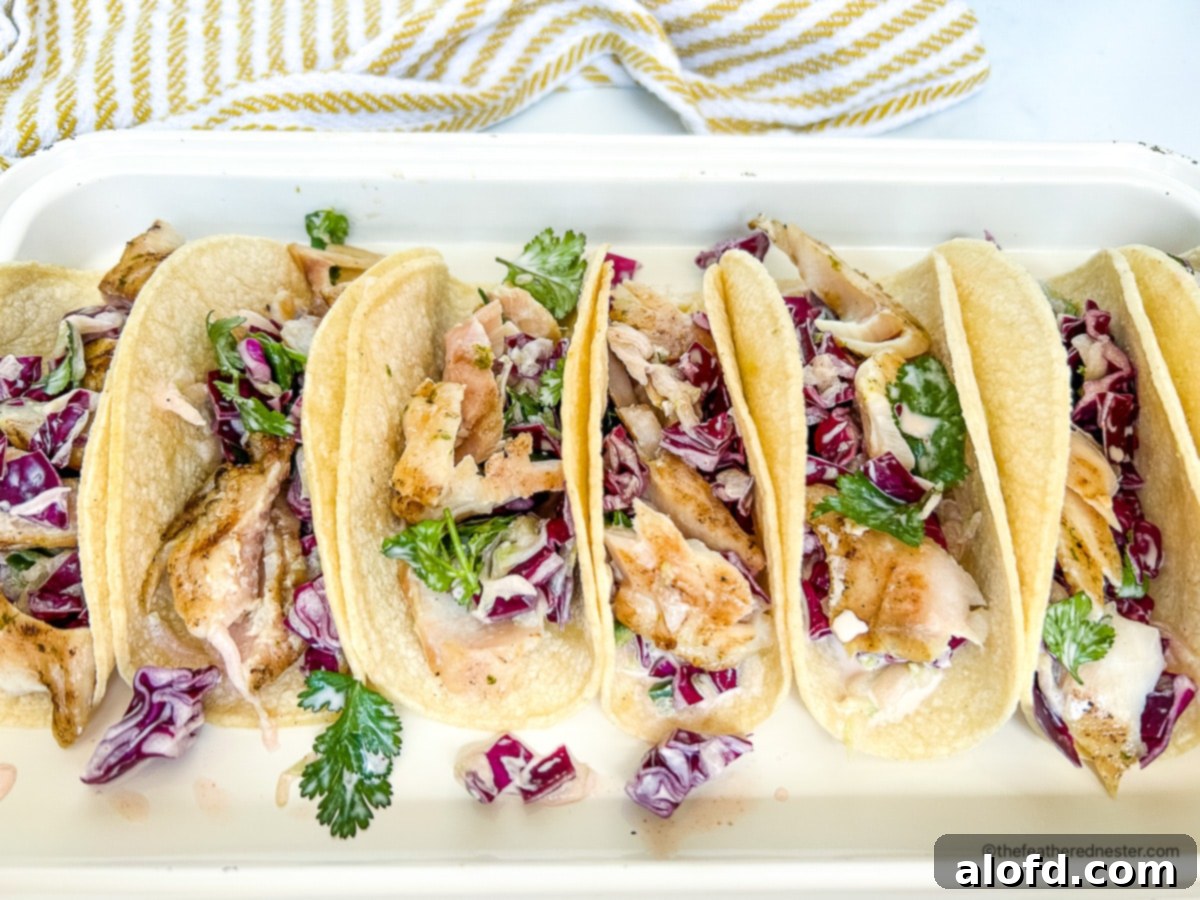Hawaiian rock cod and cucumber slaw inside of soft corn tortillas.
