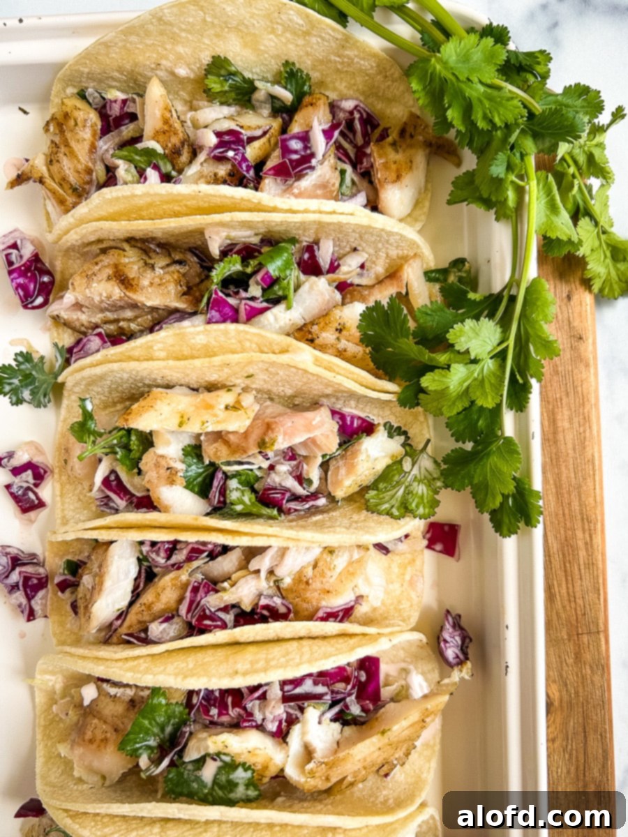 Platter of rockfish tacos topped with cucumber slaw.