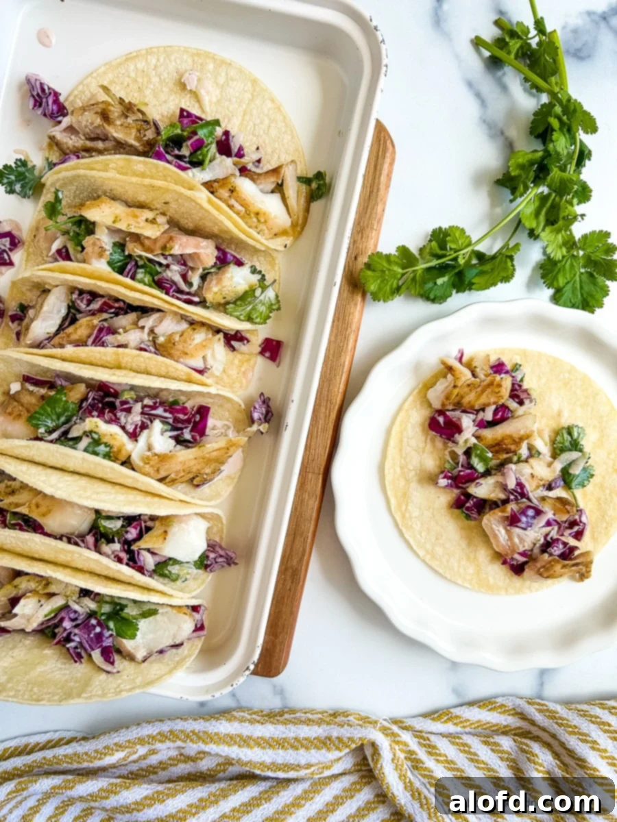 Platter full of pan seared rockfish tacos topped with fish taco slaw.