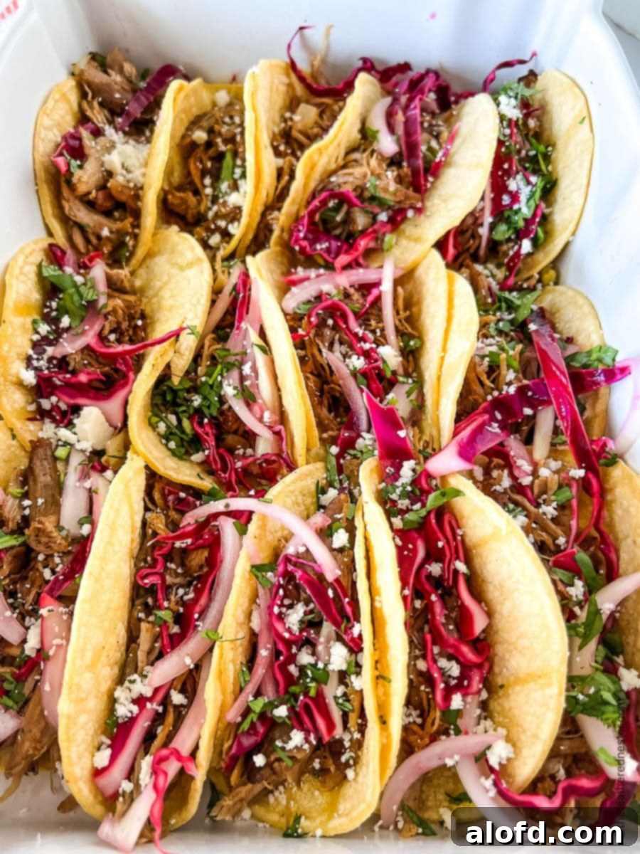 A serving dish of carnitas tacos.