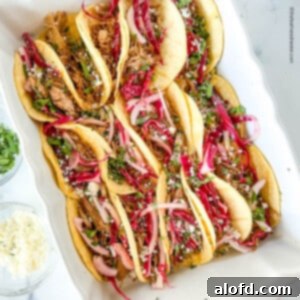 Serving dish full of pork tacos.