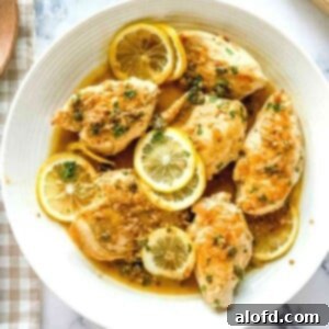 Plated dish of lemon caper chicken cutlets with sauce.