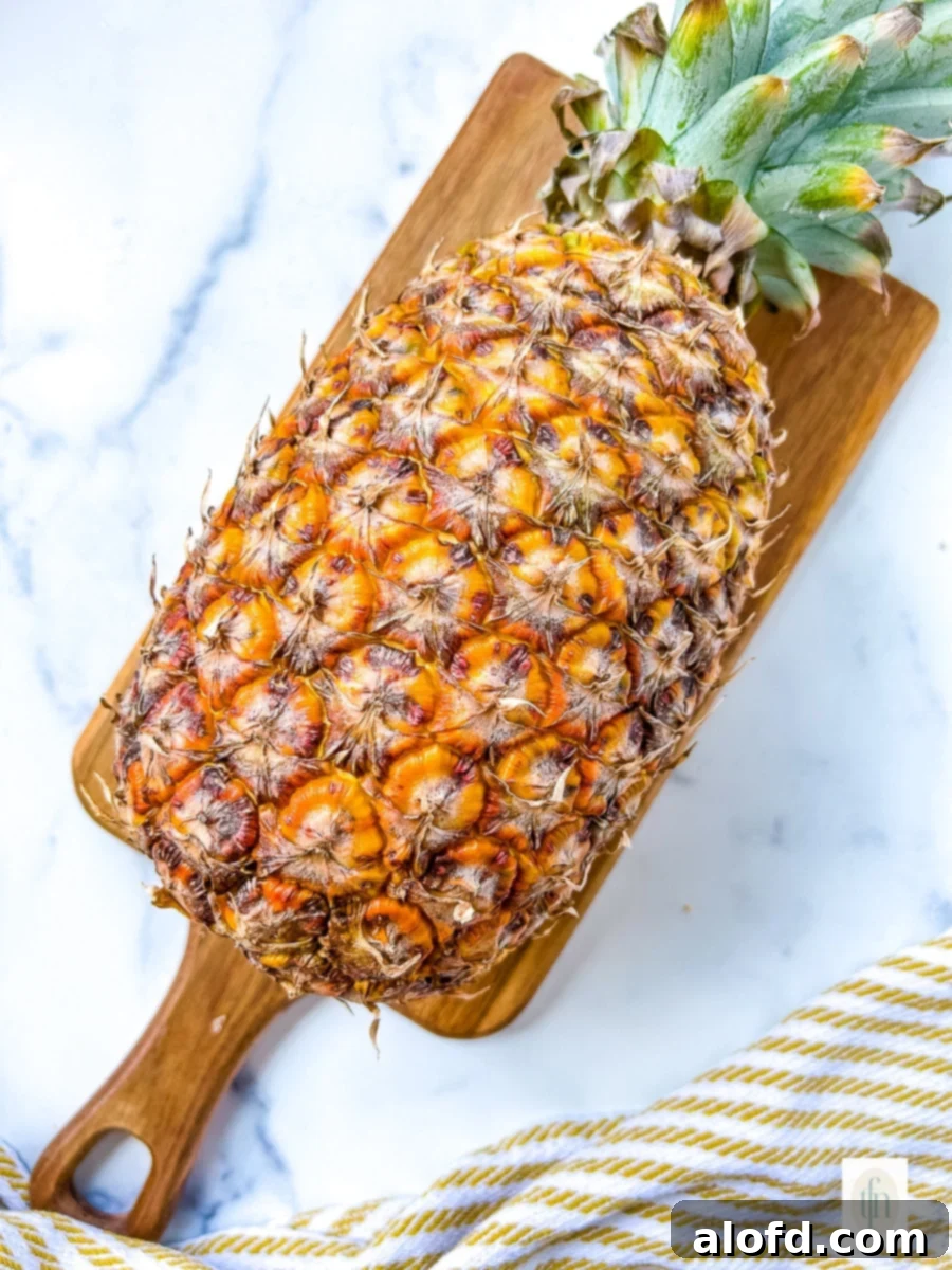 Whole pineapple before peeling and coring, symbolizing the starting point of fresh fruit preparation.