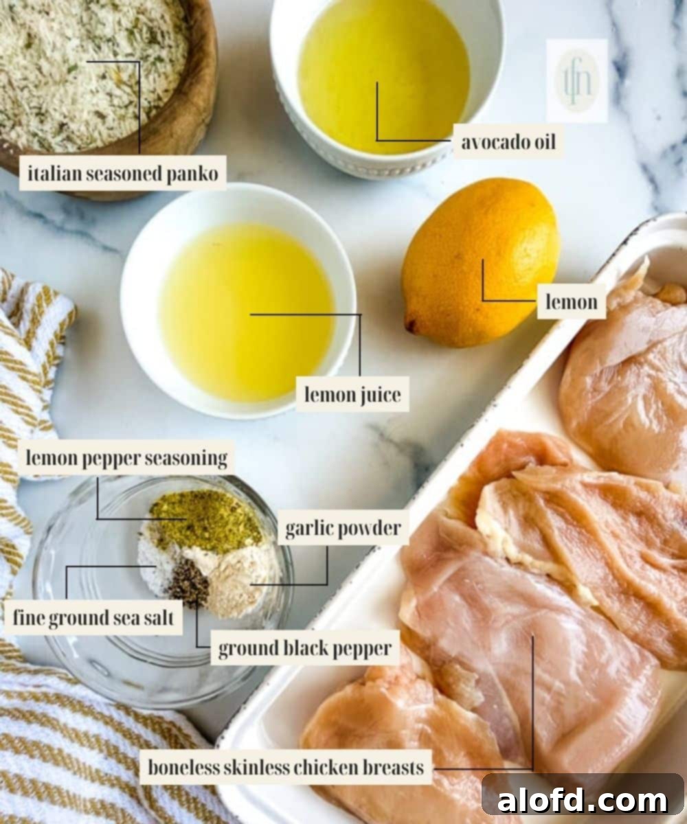 Golden Panko-Crusted Chicken Breast 3 Various ingredients for lemon panko crusted chicken laid out: chicken breasts, lemon, panko, oil, and seasonings.