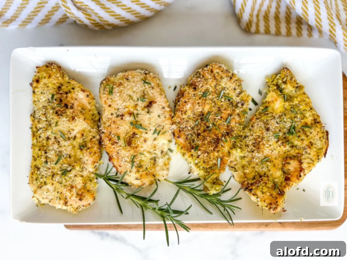 Golden Panko-Crusted Chicken Breast 8 Platter of perfectly baked panko crusted chicken pieces, garnished with lemon slices and parsley.