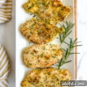 Golden Panko-Crusted Chicken Breast 9 Four panko breaded chicken breasts on a white serving platter.