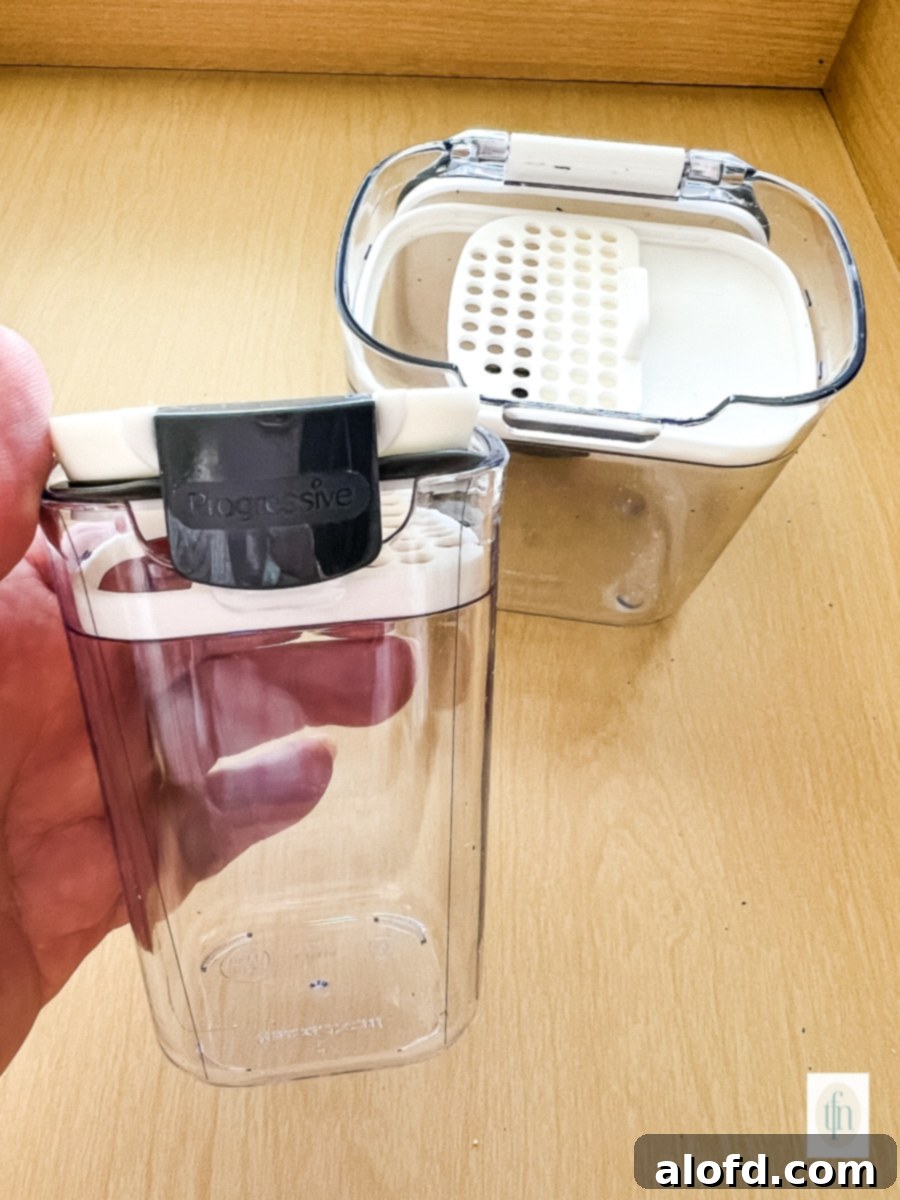 Empty plastic container with small holes on top for shaking.