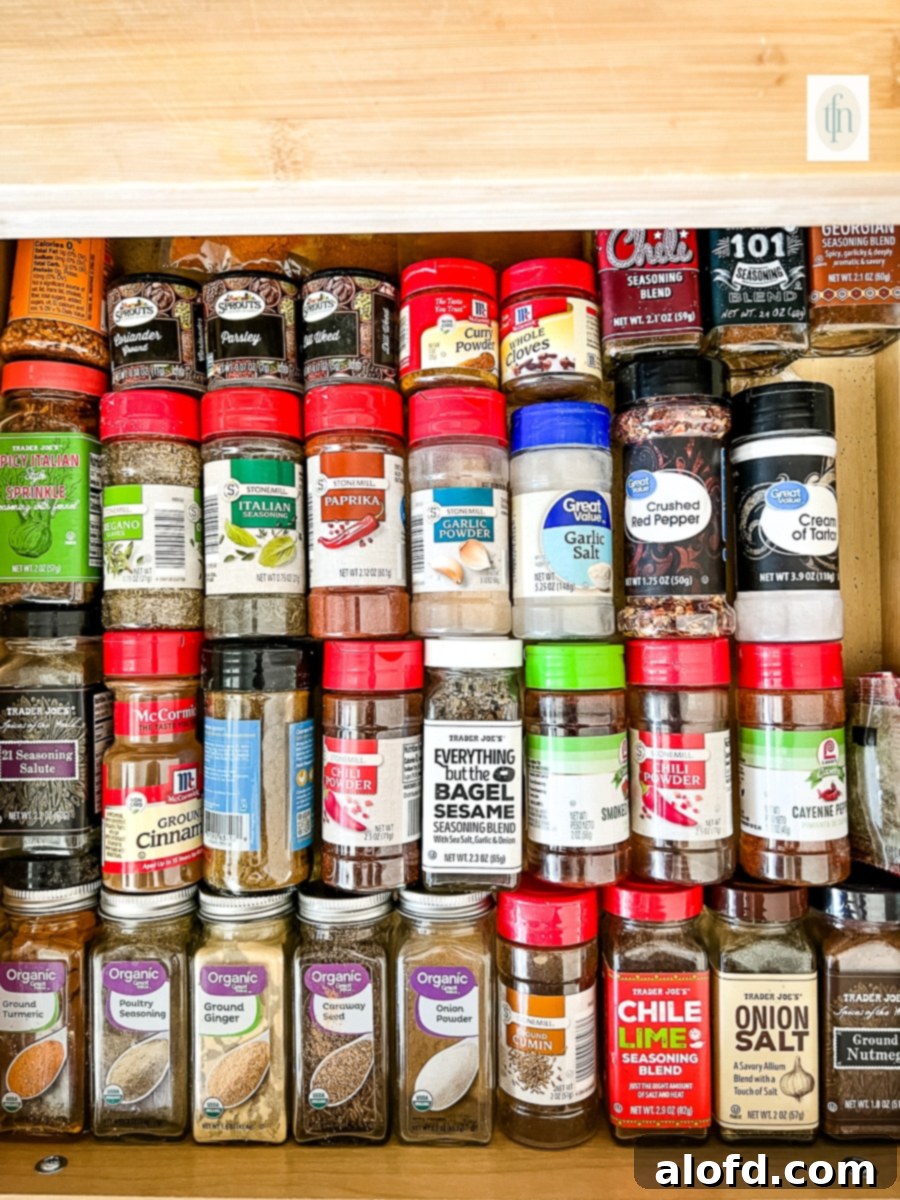 Old bottles of expired spices in a spice cabinet.