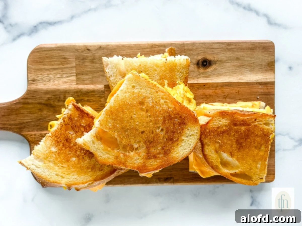 Tangy Sourdough Morning Stack 11 A platter of beautifully arranged sourdough breakfast sandwiches, garnished and ready to serve.