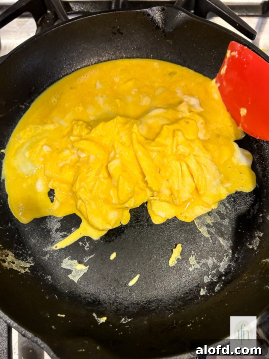 Tangy Sourdough Morning Stack 8 Fluffy scrambled eggs cooked to perfection in a non-stick skillet.