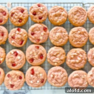 Strawberry Cheesecake Cookie Bliss 12 Baked strawberry cookies on a cooling rack, showcasing their inviting texture.
