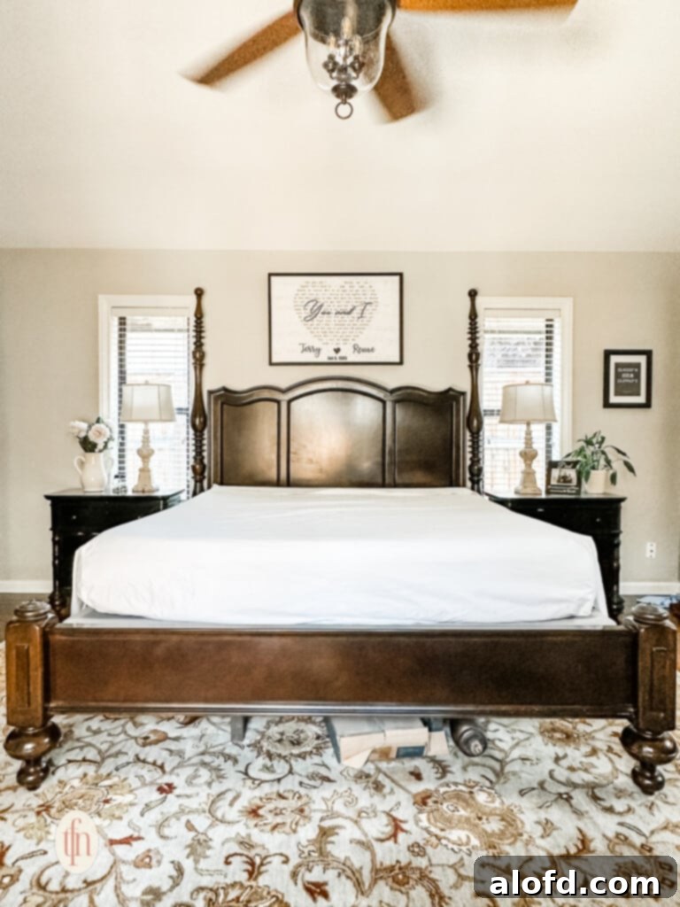 A bed in the process of being layered, with smooth, inviting sheets providing a comfortable base.