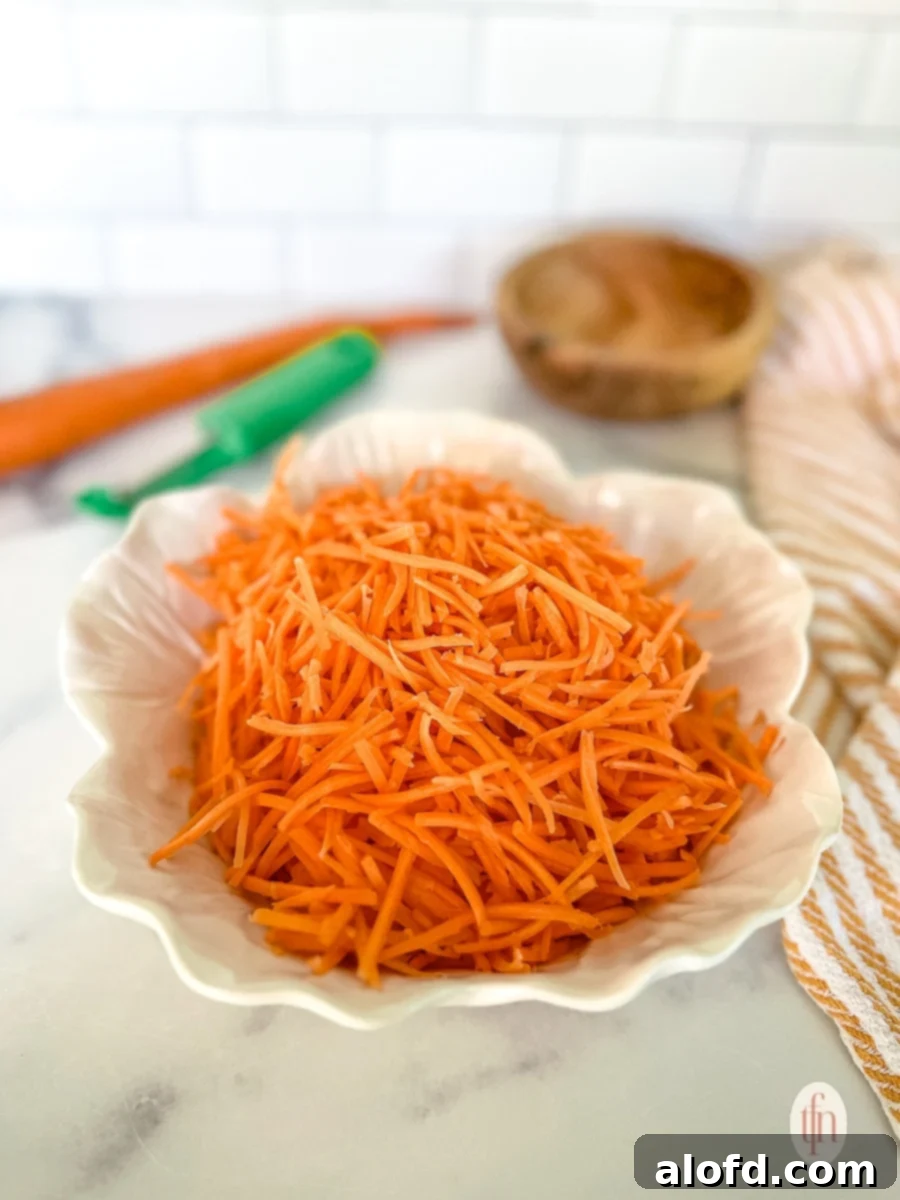 Small round serving bowl of shredded carrots.
