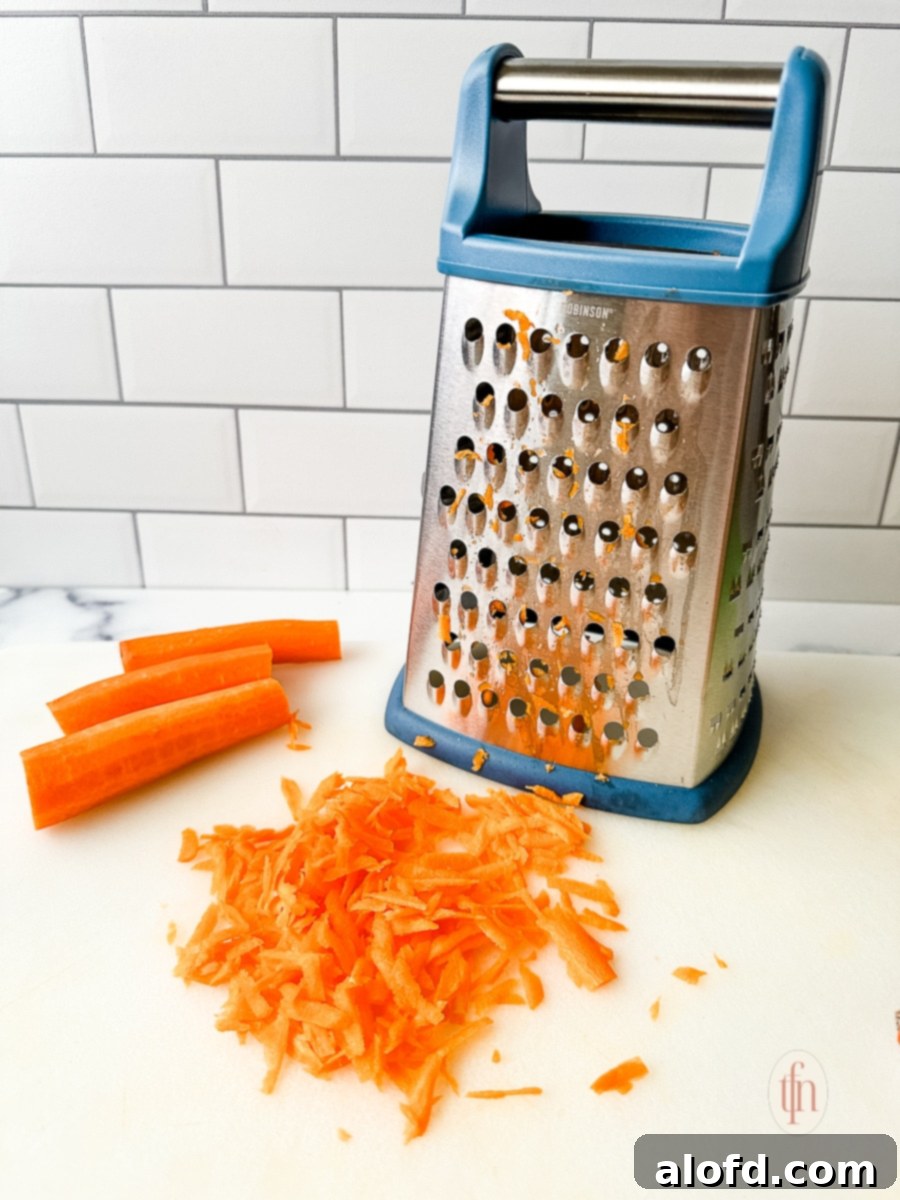 Shredding carrots on a box grater.