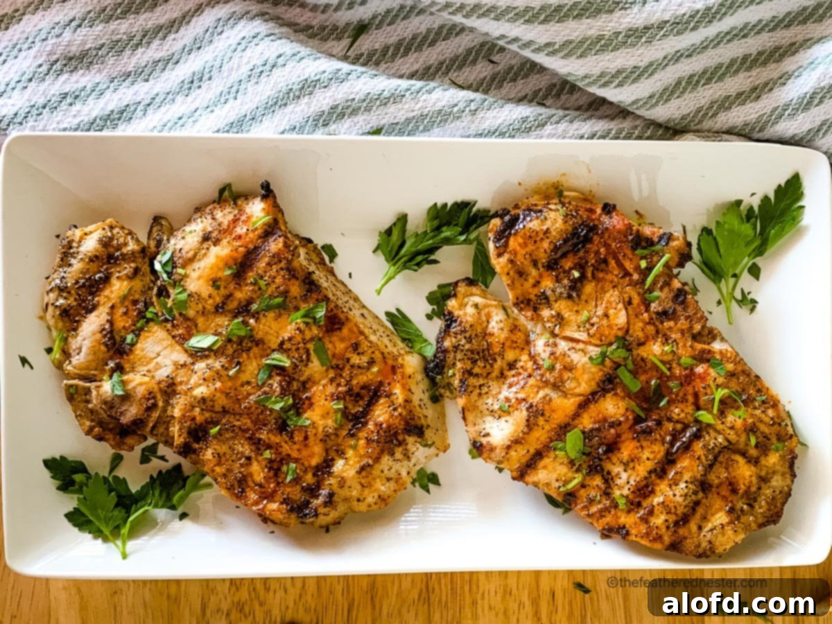 A beautifully arranged platter of perfectly cooked, tender pork chops, garnished and ready to be served for a delightful meal.