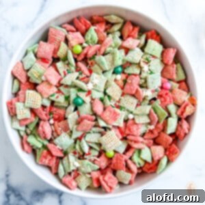 Festive Muddy Buddies 12 Bowl with candy coated cereal with sprinkles and other small festive candies on top.