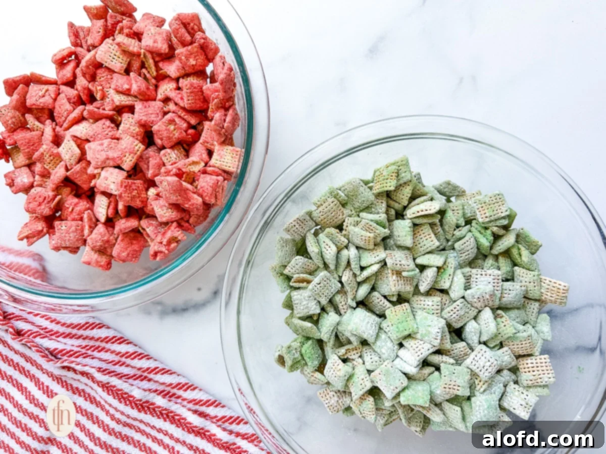 Festive Muddy Buddies 9 Two large glass bowls - one filled with red colored cereal and the other filled with green colored cereal.