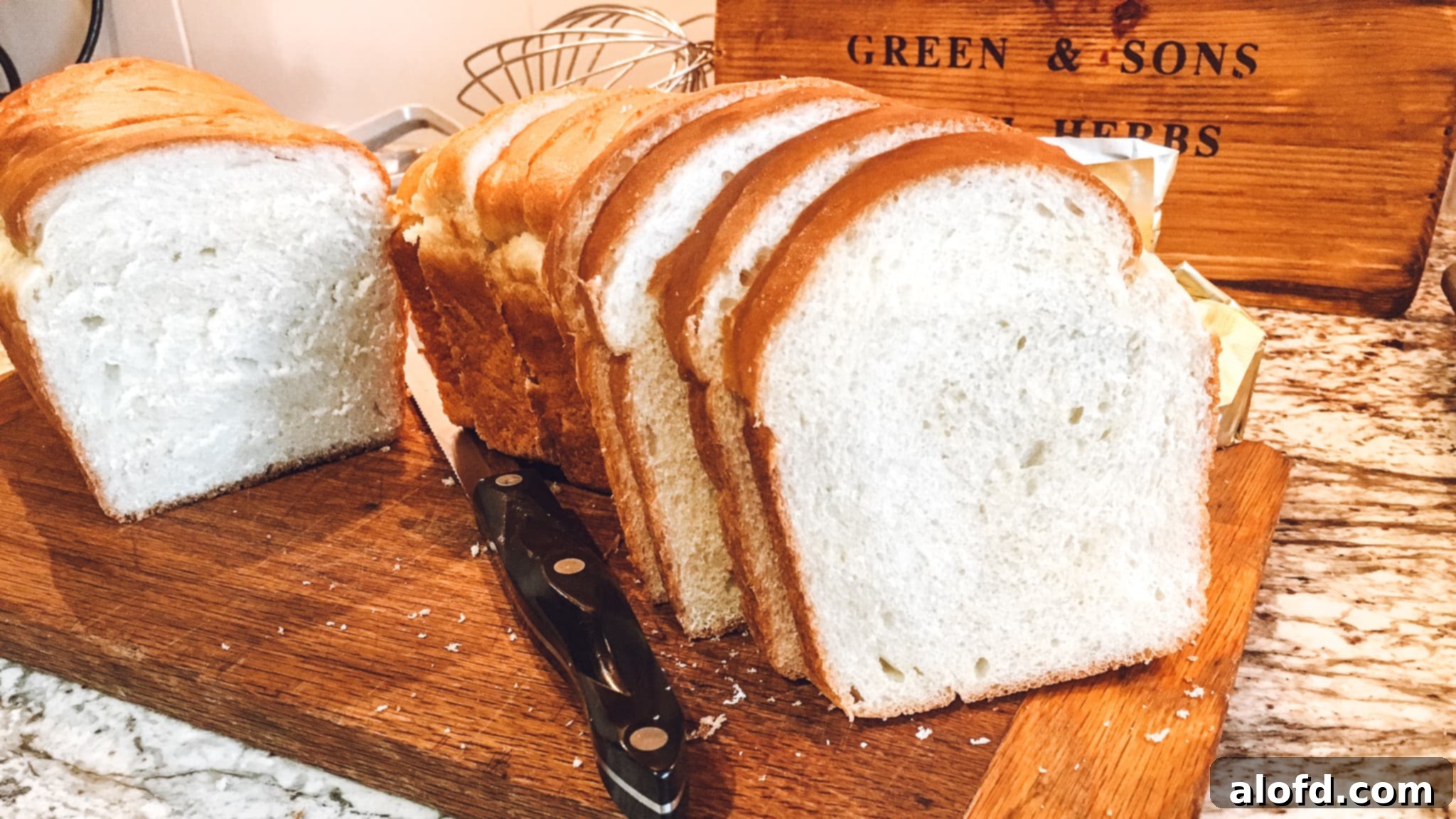 Homemade Fluffy Sandwich Bread 3 Perfectly baked and sliced classic sandwich bread, showcasing its soft, airy texture, ready for any meal.