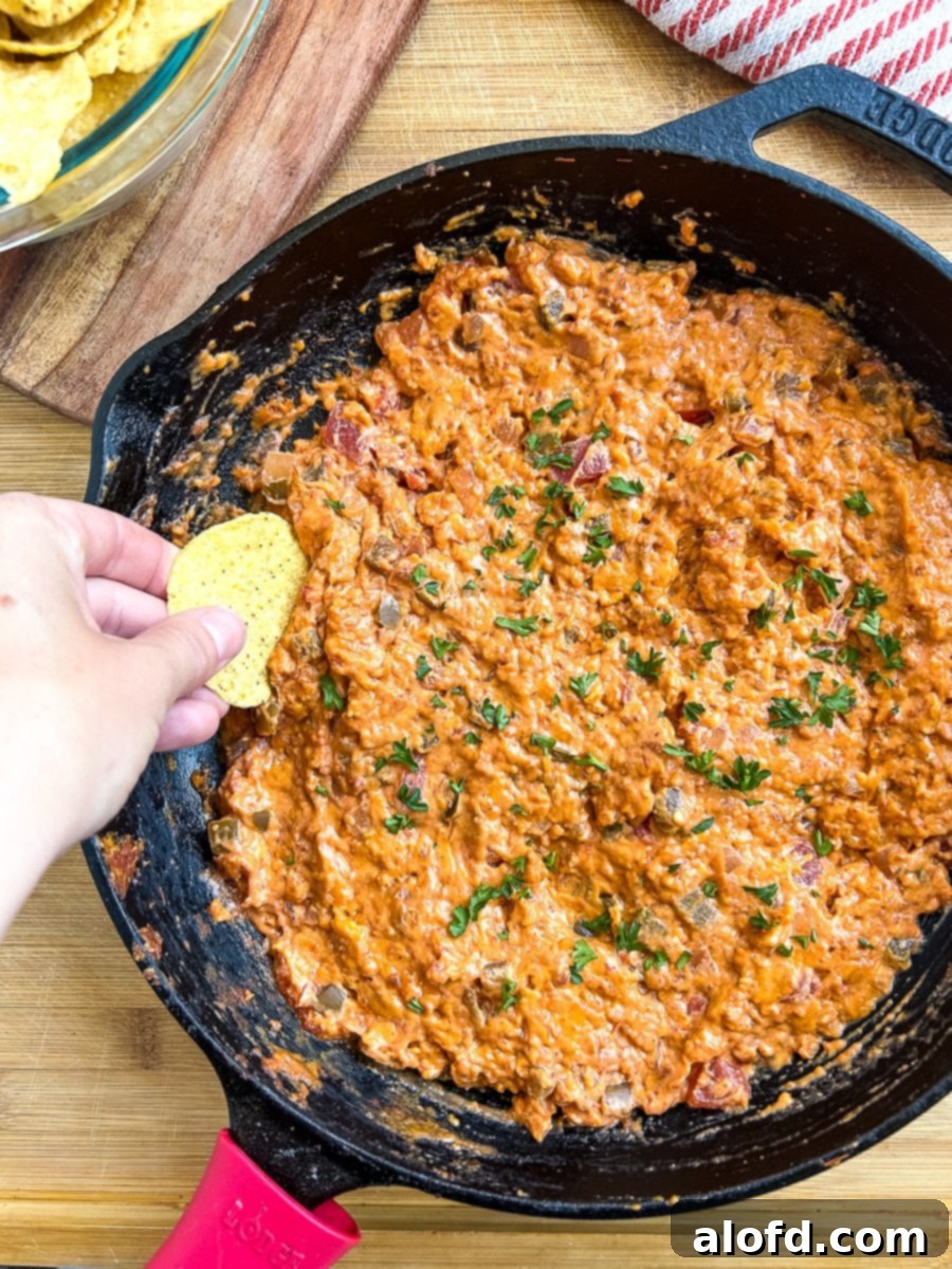 Large cast iron skillet full of smoked chorizo queso, garnished with cilantro.