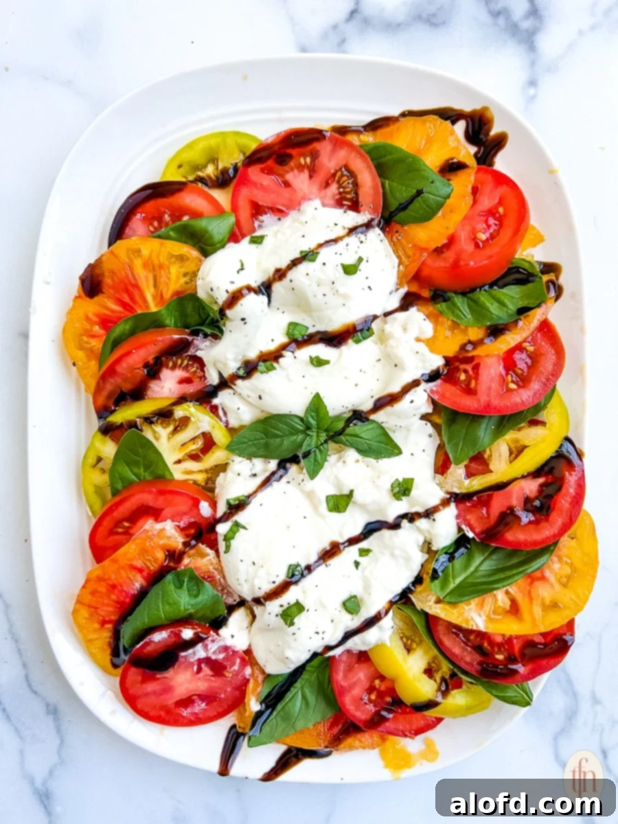 Fresh burrata caprese salad made with heirloom tomatoes.