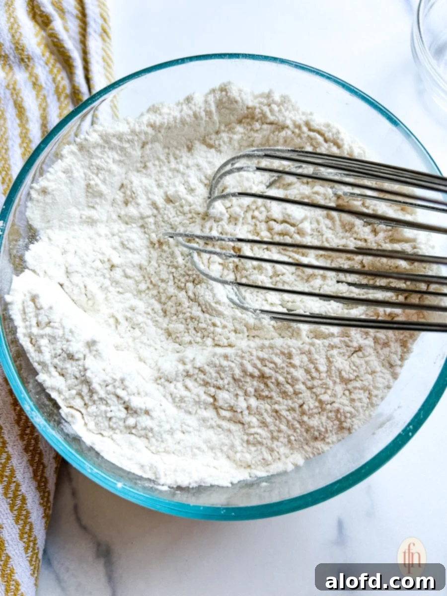 Luscious Blueberry Pound Cake 5 Whisking baking soda and salt into a bowl of all-purpose flour.