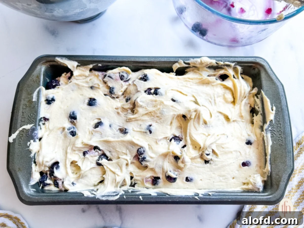 Luscious Blueberry Pound Cake 8 Unbaked blueberry dessert batter in a loaf pan.