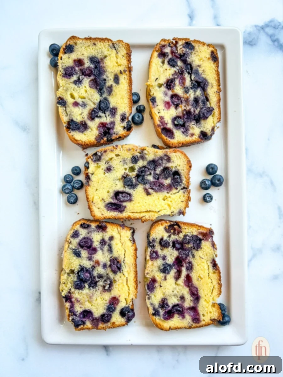 Luscious Blueberry Pound Cake 9 5 slices of blueberry pound cake laid out on a rectangular white serving platter.