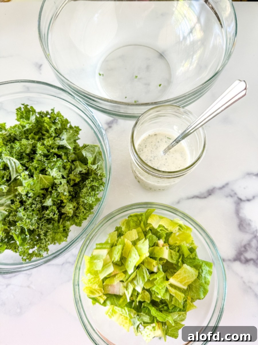 The Ultimate Green Goddess Salad 6 Ingredients for salad in glass bowls on a counter.