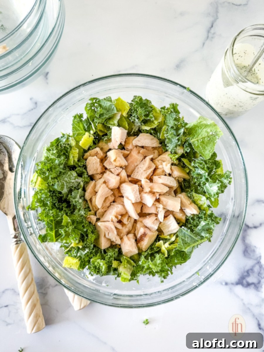 The Ultimate Green Goddess Salad 8 Lettuce and chicken in a glass bowl.