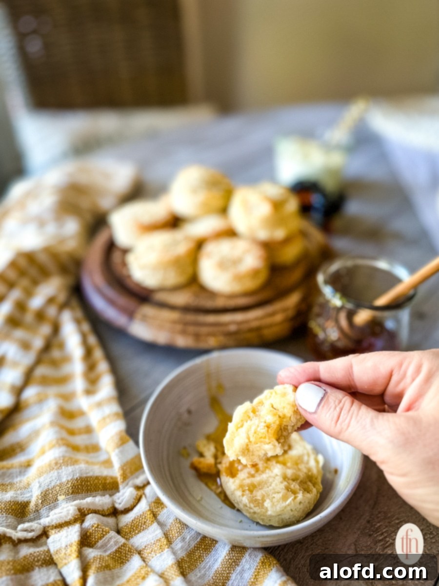 Buttermilk Biscuits with a Tangy Twist 3 Biscuits on a bowl and a platter of biscuits.