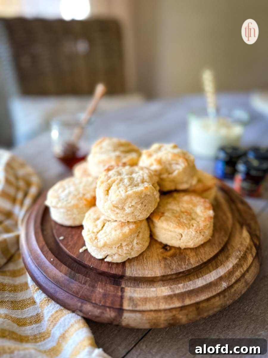 Buttermilk Biscuits with a Tangy Twist 4 A wooden platter of stacked biscuits.