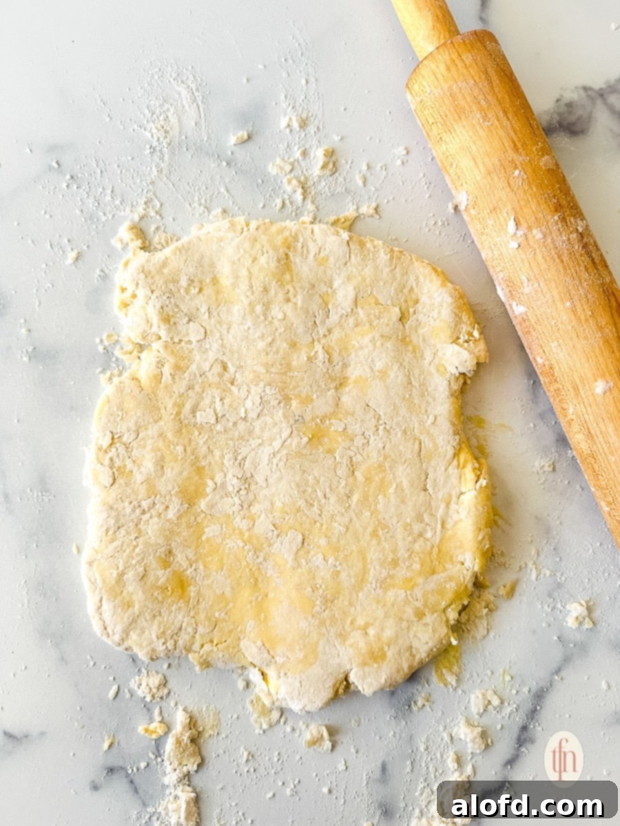Buttermilk Biscuits with a Tangy Twist 9 Rolled dough next to a rolling pin.