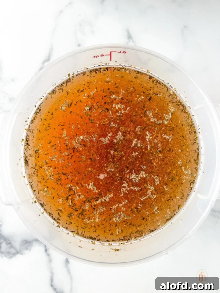 Bold Cajun Turkey Brine 3 Cajun turkey brine in a large bucket on a white surface.