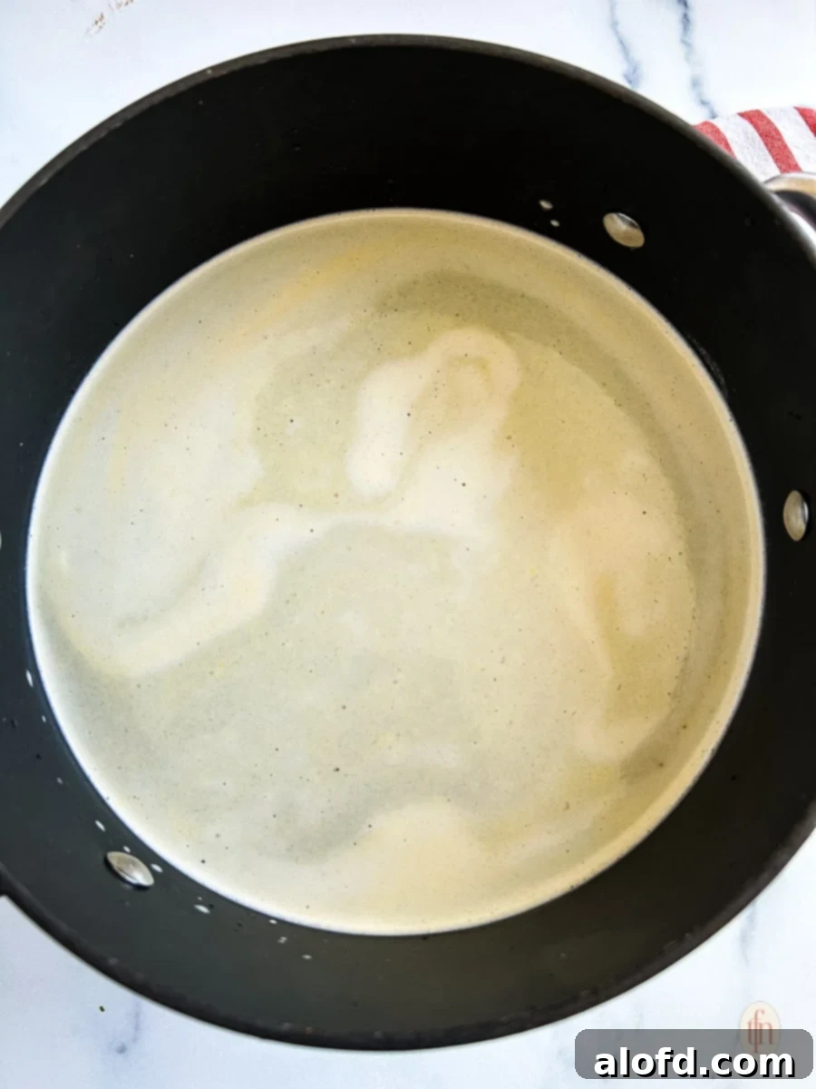 Bold Cajun Turkey Brine 6 Broth in a big pot on the stove.